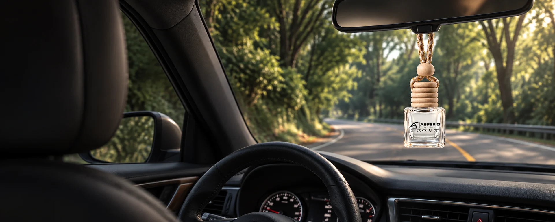 Asperio diffuser hanging inside a car overlooking a quiet, tree-lined road