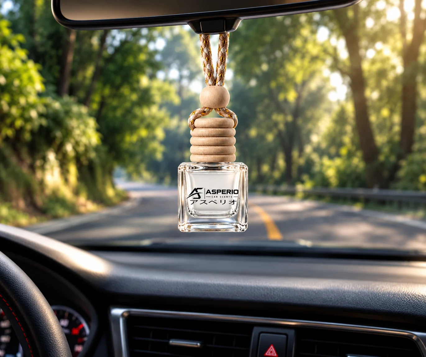 Asperio car diffuser photographed against a sunlit, tree-lined road